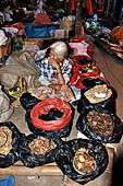The market of Makale - stalls selling local produce including coffee, tobacco, buckets of live eels, piles of fresh and dried fish, and jugs of  'balok'