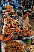 The market of Makale - stalls selling local produce including coffee, tobacco, buckets of live eels, piles of fresh and dried fish, and jugs of  'balok'