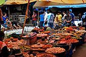 The market of Makale - stalls selling local produce including coffee, tobacco, buckets of live eels, piles of fresh and dried fish, and jugs of  'balok'