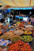 The market of Makale - stalls selling local produce including coffee, tobacco, buckets of live eels, piles of fresh and dried fish, and jugs of  'balok'