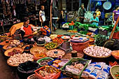 The market of Makale - stalls selling local produce including coffee, tobacco, buckets of live eels, piles of fresh and dried fish, and jugs of  'balok'