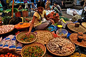 The market of Makale - stalls selling local produce including coffee, tobacco, buckets of live eels, piles of fresh and dried fish, and jugs of  'balok'