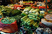 The market of Makale - stalls selling local produce including coffee, tobacco, buckets of live eels, piles of fresh and dried fish, and jugs of  'balok' 