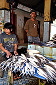The market of Makale - stalls selling local produce including coffee, tobacco, buckets of live eels, piles of fresh and dried fish, and jugs of  'balok' 