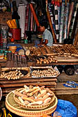 The market of Makale - stalls selling local produce including coffee, tobacco, buckets of live eels, piles of fresh and dried fish, and jugs of  'balok' 