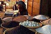 The market of Makale - stalls selling local produce including coffee, tobacco, buckets of live eels, piles of fresh and dried fish, and jugs of  'balok' 