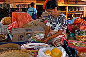The market of Makale - stalls selling local produce including coffee, tobacco, buckets of live eels, piles of fresh and dried fish, and jugs of  'balok' 