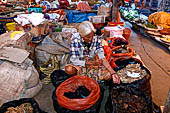 The market of Makale - stalls selling local produce including coffee, tobacco, buckets of live eels, piles of fresh and dried fish, and jugs of  'balok' 