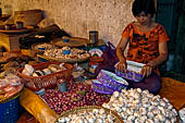 The market of Makale - stalls selling local produce including coffee, tobacco, buckets of live eels, piles of fresh and dried fish, and jugs of  'balok' 