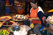The market of Makale - stalls selling local produce including coffee, tobacco, buckets of live eels, piles of fresh and dried fish, and jugs of  'balok' 