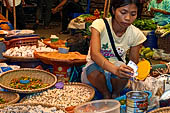 The market of Makale - stalls selling local produce including coffee, tobacco, buckets of live eels, piles of fresh and dried fish, and jugs of  'balok' 