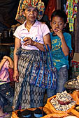 The market of Makale - stalls selling local produce including coffee, tobacco, buckets of live eels, piles of fresh and dried fish, and jugs of  'balok' 