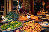 The market of Makale - stalls selling local produce including coffee, tobacco, buckets of live eels, piles of fresh and dried fish, and jugs of  'balok' 