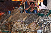 The market of Makale - stalls selling local produce including coffee, tobacco, buckets of live eels, piles of fresh and dried fish, and jugs of  'balok' 