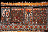 Pallawa - Traditional tongkonan house. The exterior walls are covered with wood panels etched with geometric patterns and painted with black and red colours. 