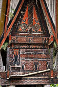 Pallawa - Traditional tongkonan house. The exterior walls are covered with wood panels etched with geometric patterns and painted with black and red colours. 