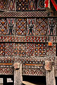 Pallawa - Traditional tongkonan house. The exterior walls are covered with wood panels etched with geometric patterns and painted with black and red colours. 