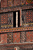 Pallawa - Traditional tongkonan house. The exterior walls are covered with wood panels etched with geometric patterns and painted with black and red colours.  