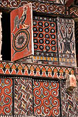 Pallawa - Traditional tongkonan house. The exterior walls are covered with wood panels etched with geometric patterns and painted with black and red colours.  