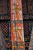 Pallawa - Traditional tongkonan house. The exterior walls are covered with wood panels etched with geometric patterns and painted with black and red colours.  
