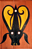 Pallawa - Traditional tongkonan house. The exterior walls are covered with wood panels etched with geometric patterns and painted with black and red colours.  