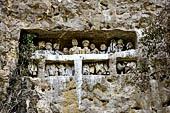 Suaya village, king's stone memorial graves, bodies placed in rock-hewn niches behind wooden effigies of the dead (known as tau tau) 
